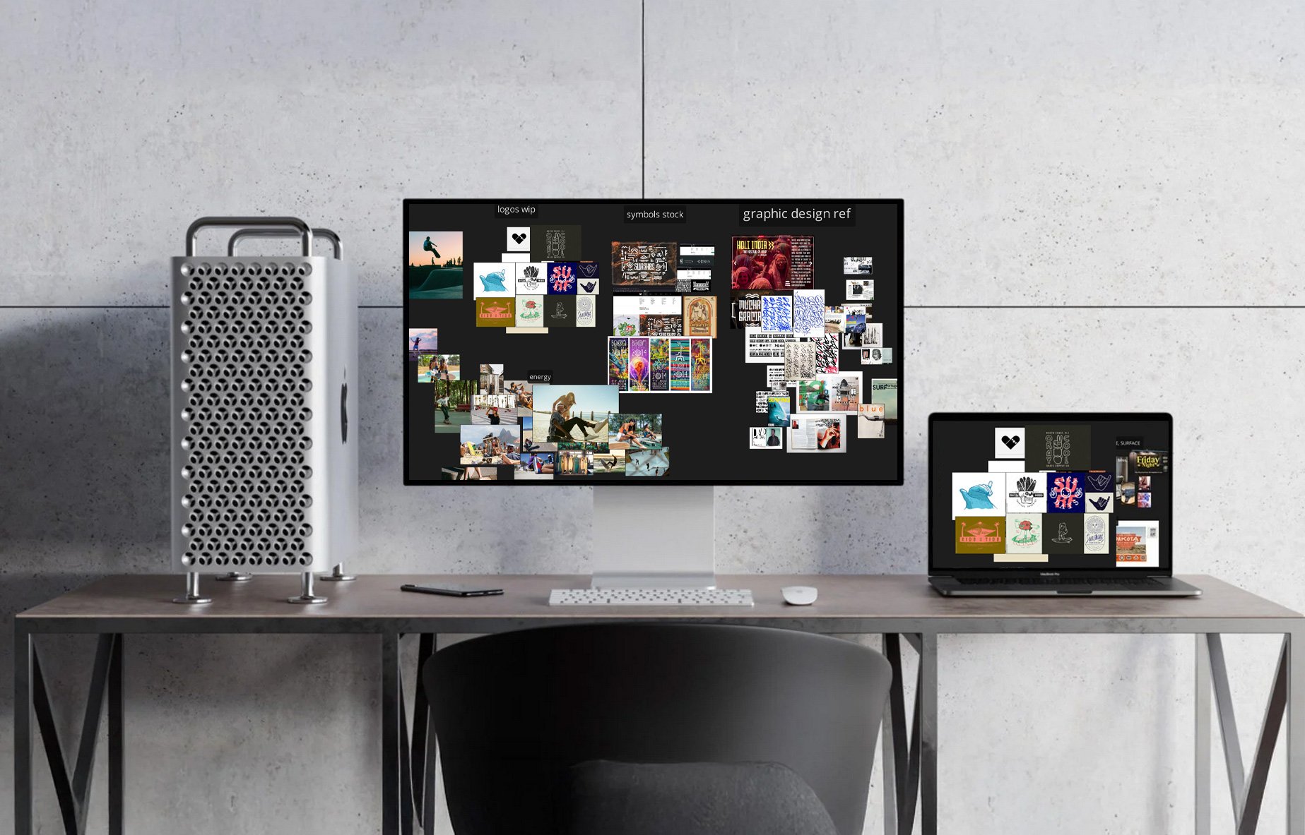 A workspace with a large desktop monitor and a laptop, both displaying an collage of various images and graphics. To the left of the monitor, there is a unique white computer tower with a perforated front panel, on a wooden desk against a plain gray wall.